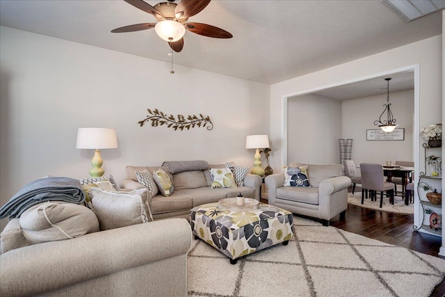 living room featuring hardwood / wood-style floors and ceiling fan