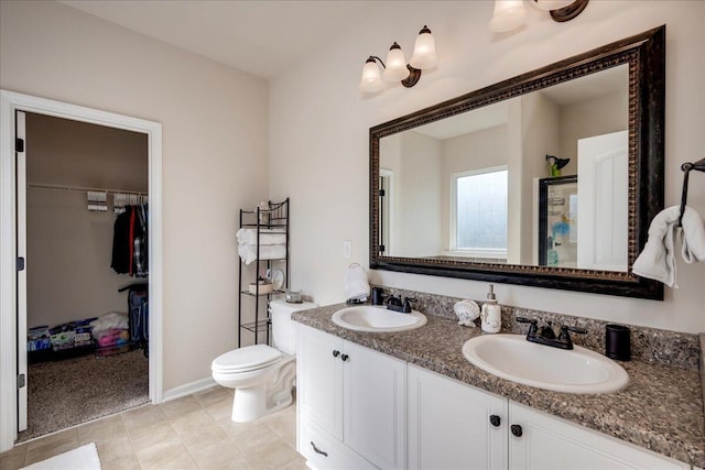 bathroom featuring tile patterned floors, vanity, and toilet