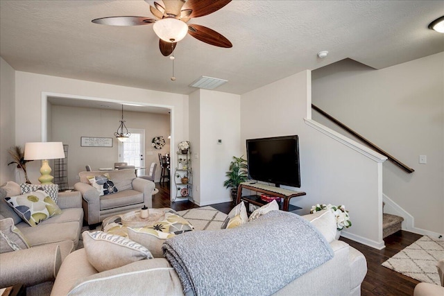 living room featuring ceiling fan, a textured ceiling, and hardwood / wood-style flooring