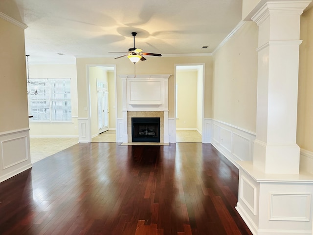 561 Farmington Cir, Evans, GA 30809 - unfurnished living room featuring a ceiling fan, hardwood / wood-style flooring, a decorative wall, a wainscoted wall, and crown molding