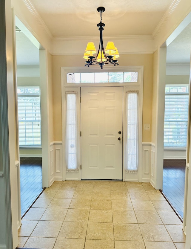 561 Farmington Cir, Evans, GA 30809 - entryway with a decorative wall, light tile patterned flooring, a chandelier, healthy amount of natural light, and a wainscoted wall
