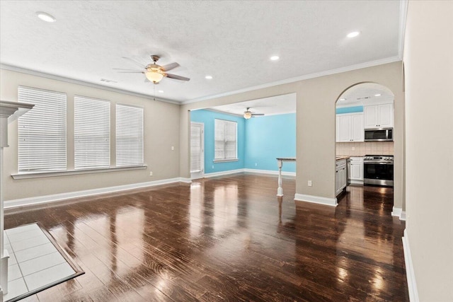1717 Ethan Way, Hephzibah, GA 30815 - unfurnished living room featuring a ceiling fan, ornamental molding, wood-type flooring, a textured ceiling, and arched walkways