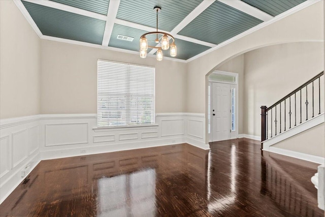 1717 Ethan Way, Hephzibah, GA 30815 - empty room featuring arched walkways, a chandelier, wood finished floors, wainscoting, and stairs