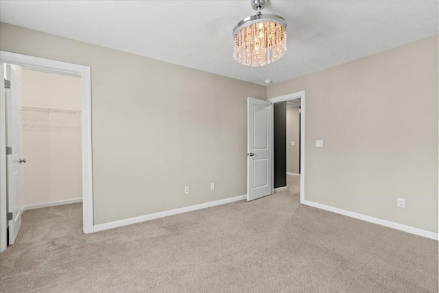 1717 Ethan Way, Hephzibah, GA 30815 - unfurnished bedroom featuring carpet, a chandelier, a walk in closet, and a closet