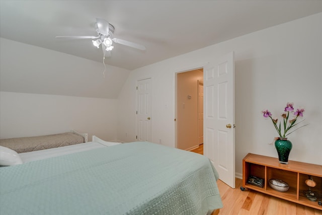 bedroom with lofted ceiling, ceiling fan, and light wood finished floors