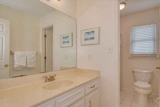 bathroom featuring tile patterned floors, vanity, toilet, and baseboards