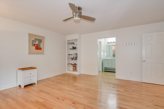 unfurnished bedroom with baseboards, light wood-type flooring, and connected bathroom