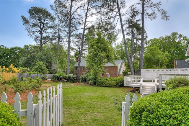view of yard with a deck and fence