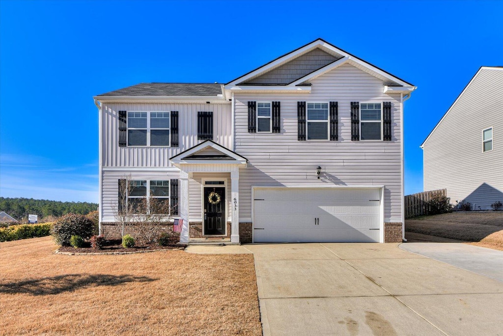 view of front facade featuring a garage and a front yard