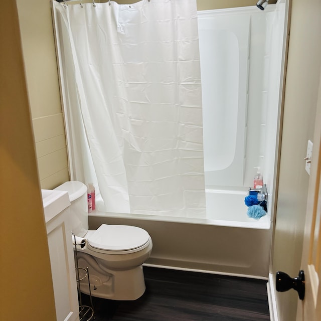 full bathroom featuring hardwood / wood-style flooring, vanity, toilet, and shower / tub combo