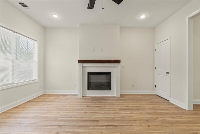 1227 Miller St, Augusta, GA 30901 - unfurnished living room with light wood finished floors, ceiling fan, a glass covered fireplace, baseboards, and recessed lighting