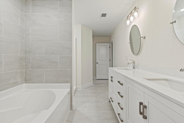 1227 Miller St, Augusta, GA 30901 - full bath featuring a garden tub, double vanity, and baseboards