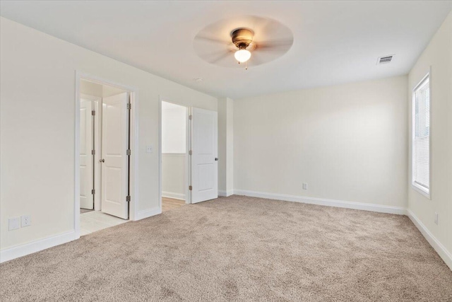 1227 Miller St, Augusta, GA 30901 - unfurnished bedroom with light carpet, baseboards, and ceiling fan