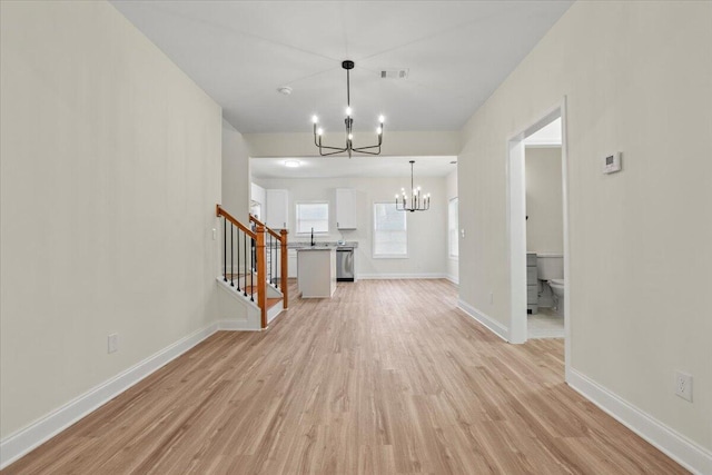 1227 Miller St, Augusta, GA 30901 - unfurnished living room featuring a chandelier, light wood-style floors, stairs, and baseboards