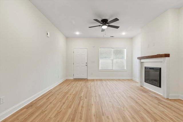 1227 Miller St, Augusta, GA 30901 - unfurnished living room with light wood-type flooring, a glass covered fireplace, ceiling fan, baseboards, and recessed lighting