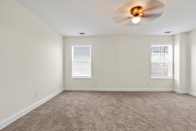 1227 Miller St, Augusta, GA 30901 - empty room with light carpet, plenty of natural light, baseboards, and a ceiling fan