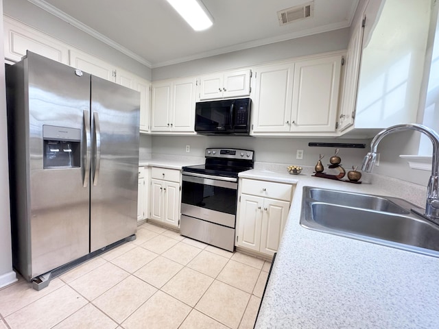 kitchen featuring visible vents, a sink, stainless steel appliances, light tile patterned flooring, and crown molding