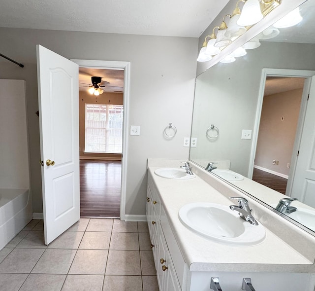 bathroom with a sink, double vanity, and tile patterned flooring