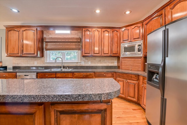 3953 Bolton St, Augusta, GA 30909 - kitchen with appliances with stainless steel finishes, light wood-type flooring, decorative backsplash, brown cabinets, and recessed lighting