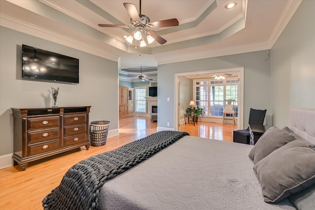 3953 Bolton St, Augusta, GA 30909 - bedroom with ornamental molding, wood finished floors, a tray ceiling, a glass covered fireplace, and recessed lighting