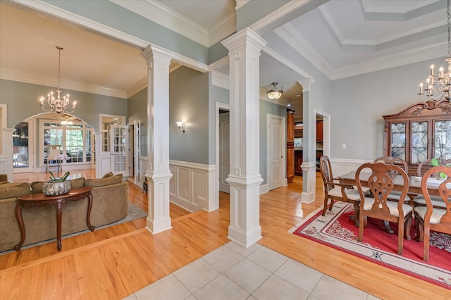 3953 Bolton St, Augusta, GA 30909 - dining space with light tile patterned floors, a chandelier, wainscoting, crown molding, and a decorative wall