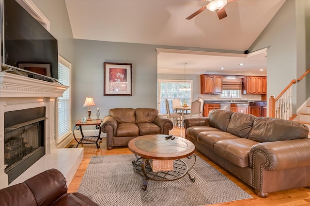 3953 Bolton St, Augusta, GA 30909 - living area featuring a ceiling fan, stairs, light wood-type flooring, lofted ceiling, and a fireplace with raised hearth