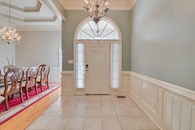 3953 Bolton St, Augusta, GA 30909 - foyer entrance with a chandelier, a decorative wall, ornamental molding, wainscoting, and light tile patterned floors