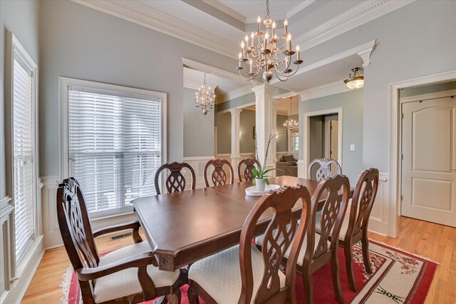 3953 Bolton St, Augusta, GA 30909 - dining room featuring a chandelier, ornamental molding, light wood-style floors, a wainscoted wall, and decorative columns