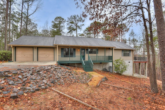 ranch-style home featuring a garage, stairway, a porch, and concrete driveway