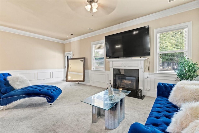 556 Ernestine Fls, Grovetown, GA 30813 - carpeted living room featuring ceiling fan, ornamental molding, a decorative wall, a wainscoted wall, and a fireplace with flush hearth
