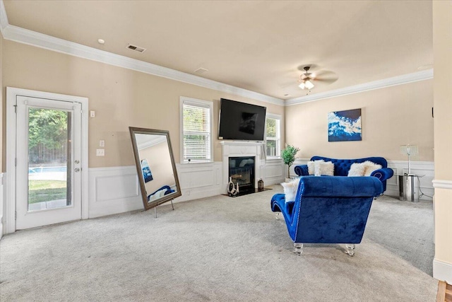 556 Ernestine Fls, Grovetown, GA 30813 - living room featuring ornamental molding, carpet flooring, a ceiling fan, a wainscoted wall, and a premium fireplace