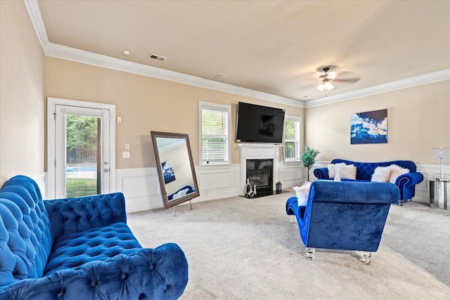 556 Ernestine Fls, Grovetown, GA 30813 - living area featuring ornamental molding, carpet flooring, wainscoting, a ceiling fan, and a premium fireplace