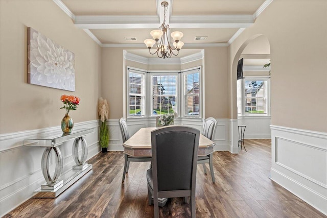 556 Ernestine Fls, Grovetown, GA 30813 - dining area with a chandelier, a wainscoted wall, crown molding, arched walkways, and wood finished floors