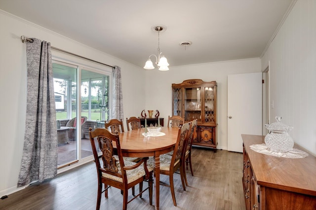 3593 Westhampton Dr, Martinez, GA 30907 - dining space featuring crown molding, wood finished floors, and a chandelier