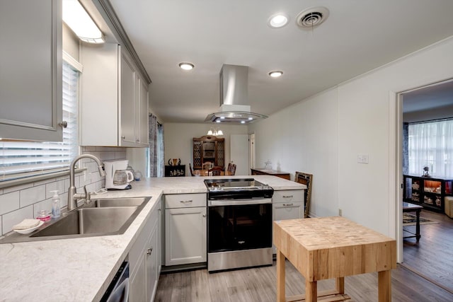 3593 Westhampton Dr, Martinez, GA 30907 - kitchen featuring stainless steel appliances, a sink, island exhaust hood, a peninsula, and light countertops