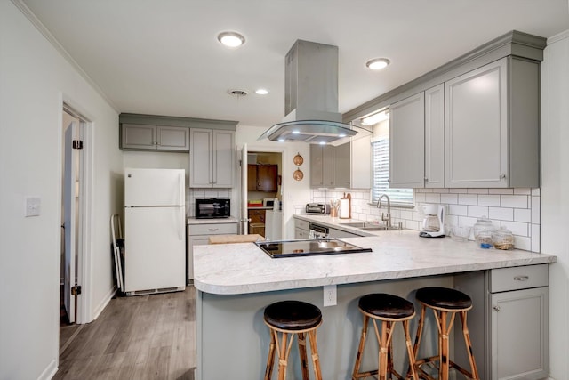 3593 Westhampton Dr, Martinez, GA 30907 - kitchen with freestanding refrigerator, gray cabinetry, a sink, island exhaust hood, and black electric cooktop