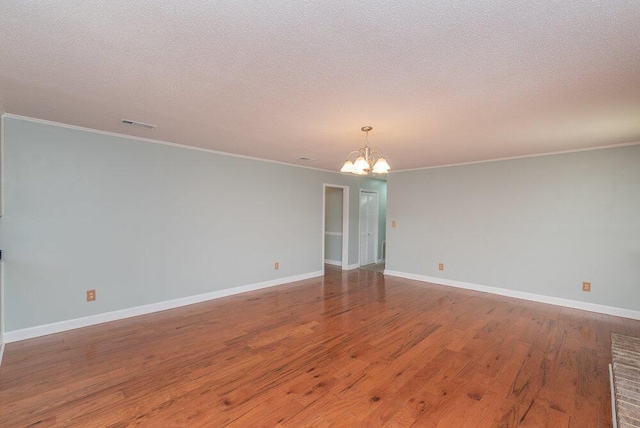 4015 Goshen Lake S, Augusta, GA 30906 - empty room featuring a chandelier, crown molding, wood finished floors, and a textured ceiling