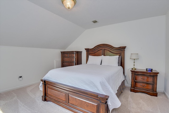 bedroom featuring baseboards, visible vents, light carpet, and lofted ceiling