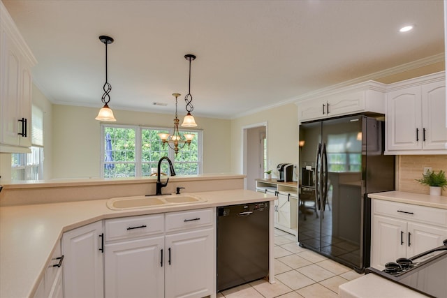 kitchen featuring decorative light fixtures, a sink, light tile patterned floors, white cabinets, and black appliances
