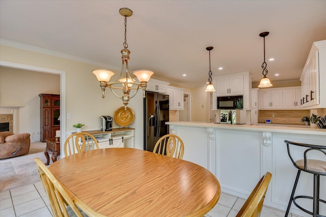 dining area featuring light tile patterned floors, ornamental molding, a fireplace, and recessed lighting