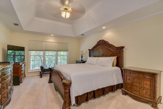 bedroom featuring crown molding, ceiling fan, light carpet, a raised ceiling, and visible vents