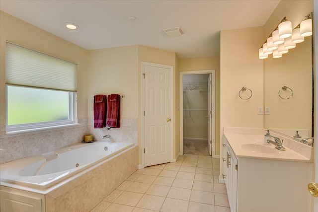 full bathroom featuring tile patterned flooring, visible vents, vanity, a tub with jets, and a spacious closet