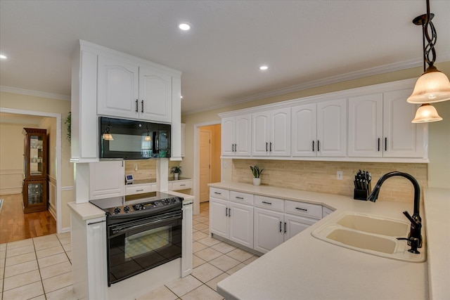 kitchen featuring a sink, light tile patterned floors, black appliances, and white cabinetry