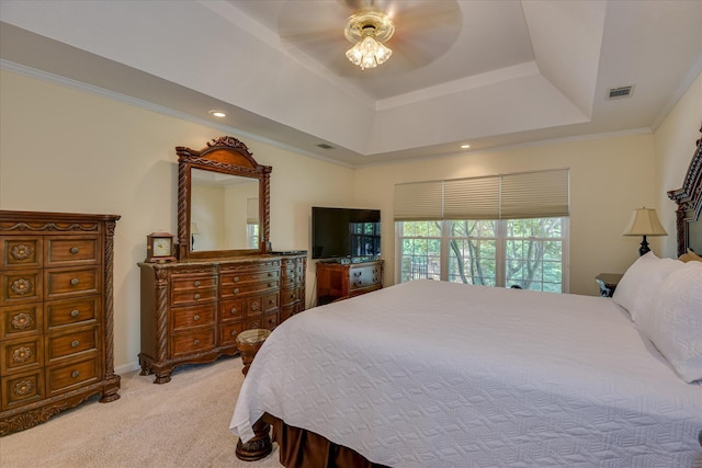 bedroom featuring crown molding, ceiling fan, light carpet, a raised ceiling, and visible vents