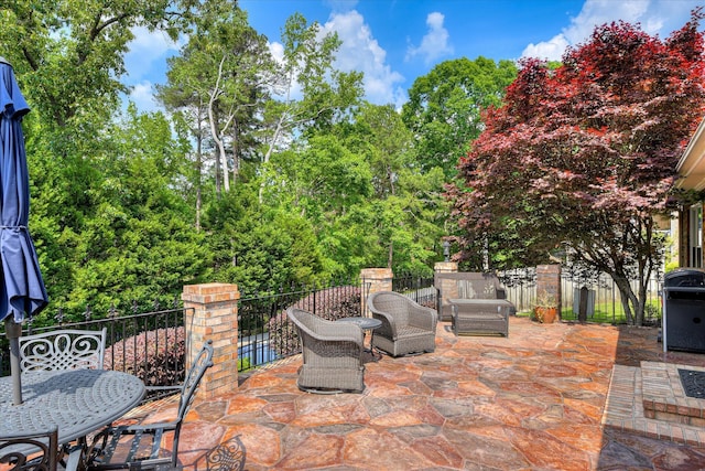 view of patio / terrace with outdoor dining space, fence, and area for grilling