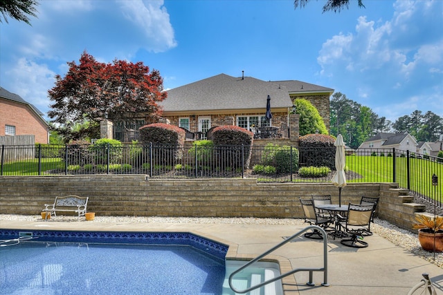 view of pool with a patio, a fenced in pool, fence, and outdoor dining area
