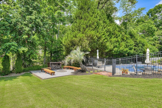 view of yard with a fenced in pool and fence