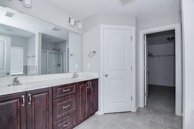 141 Caroleton Dr, Grovetown, GA 30813 - full bathroom with a shower stall, double vanity, a walk in closet, and tile patterned flooring