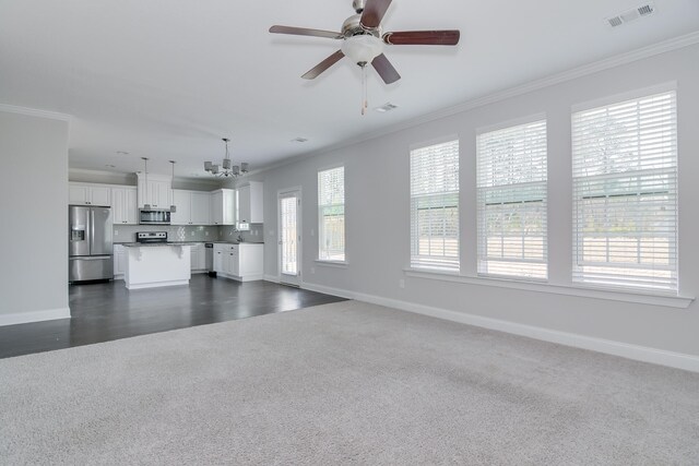 141 Caroleton Dr, Grovetown, GA 30813 - unfurnished living room with dark colored carpet, crown molding, a chandelier, and ceiling fan