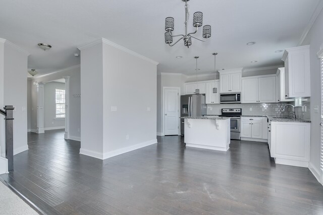 141 Caroleton Dr, Grovetown, GA 30813 - kitchen featuring stainless steel appliances, a center island, white cabinets, open floor plan, and crown molding